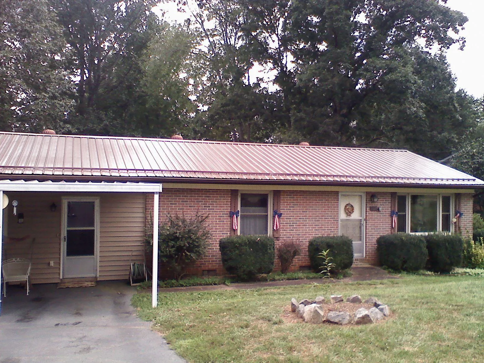 Bronze metal roof and carport on a brick ranch home — Roof Repair work by our crew in Horse Shoe